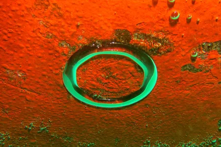 Bubbles from the divers' breathing aparatus collect on the belly of the ship.