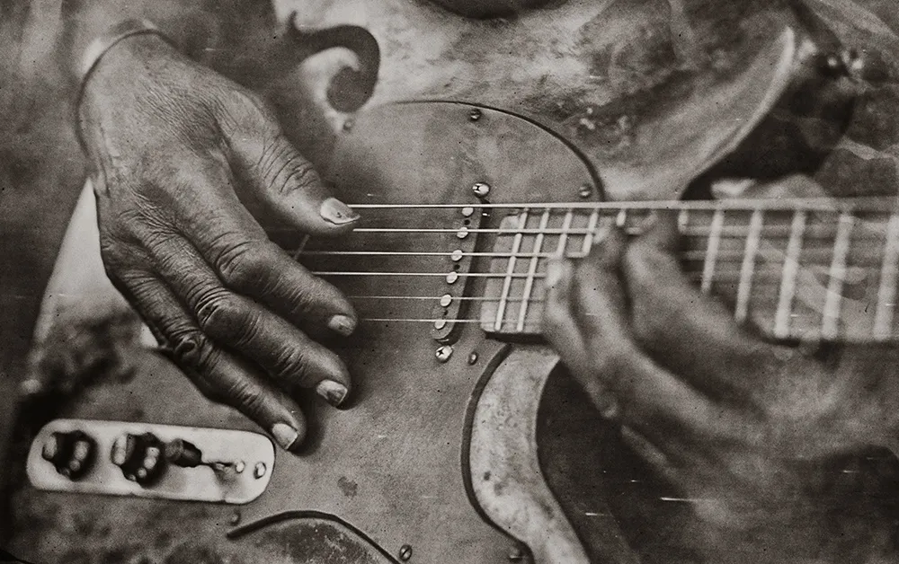 hands playing Vines' guitar social