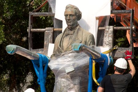 A 1933 statue of Confederate leader Jefferson Davis is removed from University of Texas' South Mall after UT President Gregory Fenves cleared it to be placed in a campus museum. 