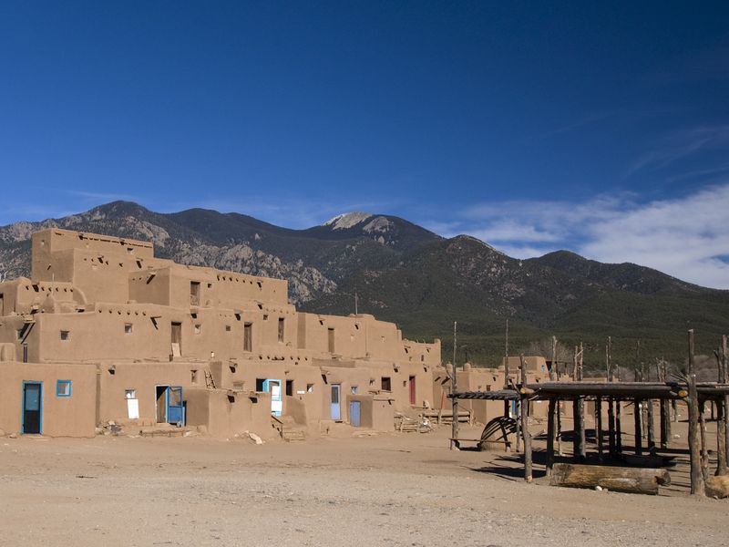 Ancient adobe architecture in the Taos pueblo against a back drop of ...