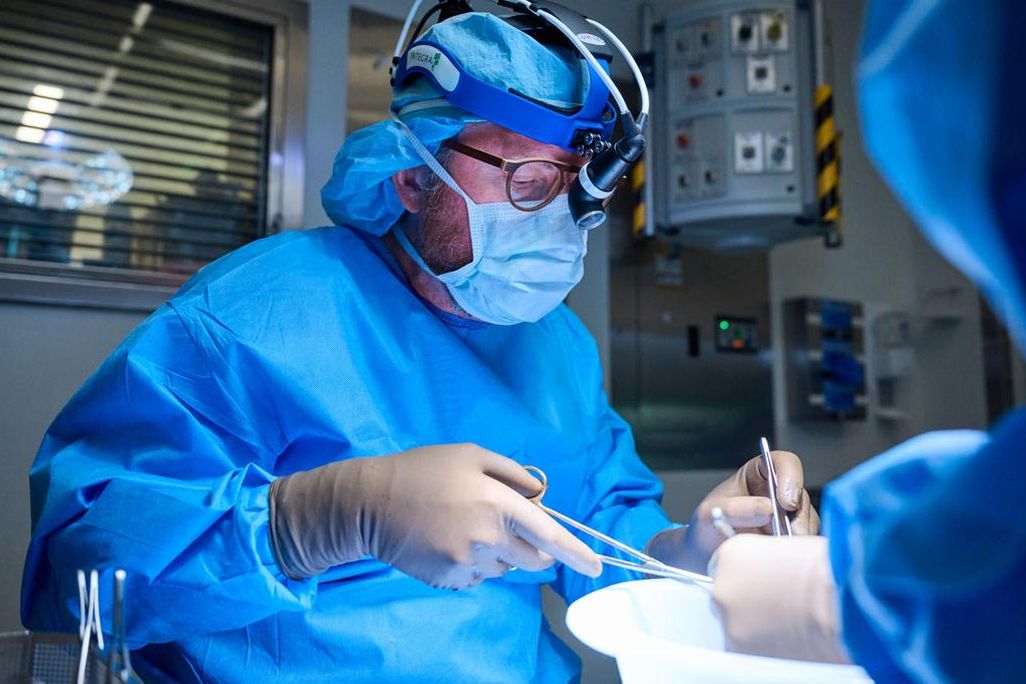 A doctor in scrubs operates