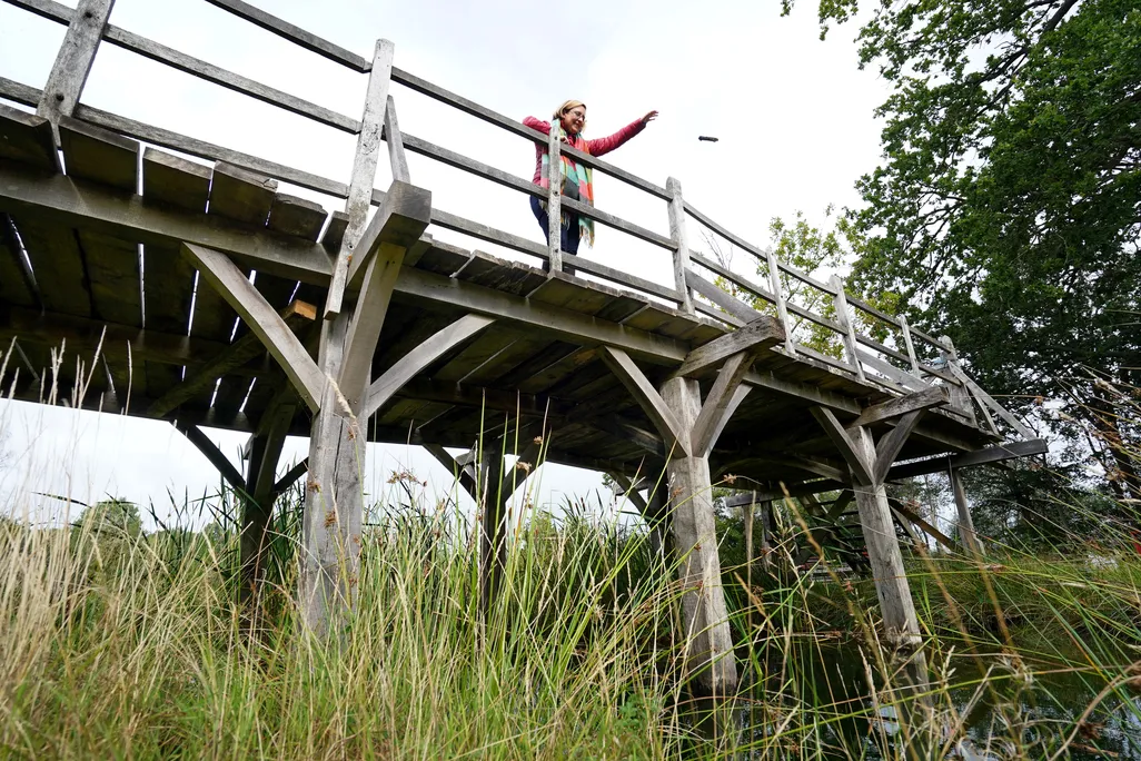 Silke Lohmann of Summers Place Auctions stands on the original Poohsticks Bridge from Ashdown Forest,