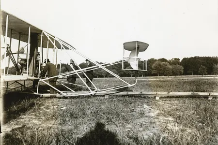 Charles Furnas at age 28 (bending over controls), when he helped the Wrights sell their Model A biplane to the Army at Fort Myer, Virginia.