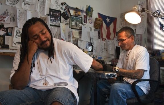 Q Monts sits patiently at Nu Flava Ink