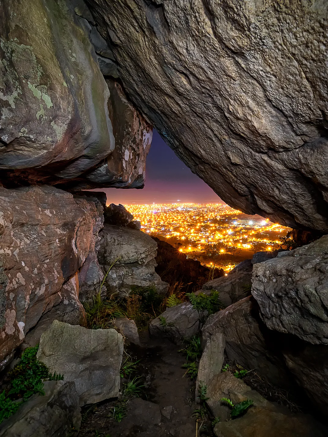 An aerial view of the city through a rock formation