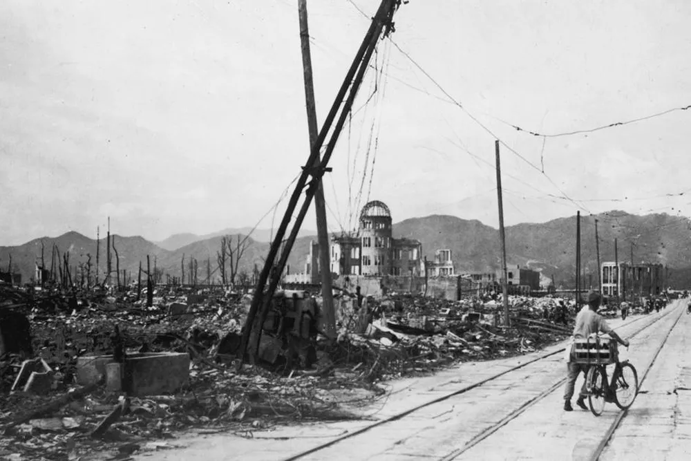 Man wheels bicycle through Hiroshima (main longform)