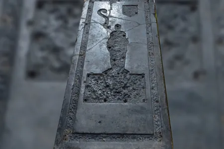 The black &quot;marble&quot; tombstone is made of limestone that likely came from Belgium.
