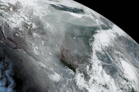 A satellite image of North America taken on August 25, 2020. Smoke from wildfires can be seen rising from California and Hurricane Laura can be seen heading toward Louisiana and eastern Texas as the remnants of Marco swirl over the Southeast.