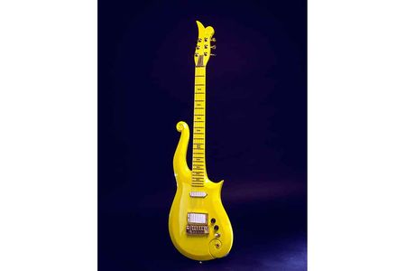 Prince designed and used this 1989 custom-made Yellow-cloud electric guitar, built by the Minneapolis firm Knut-Koupee. It features his personal symbol at the top and on the side of the fingerboard. 