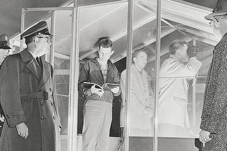 Kernersville, North Carolina observers and Air Force reps inspect a post in 1958.