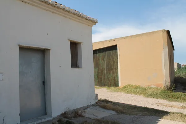 Homes  and storage buildings in  rice fields thumbnail