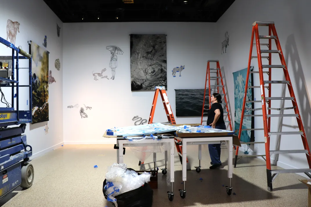 Artist in a museum exhibit under construction