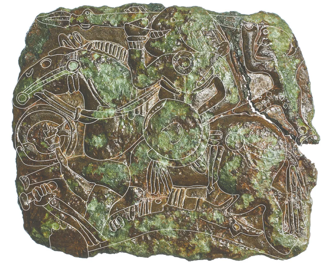 Greenish metal artifact covered in imagery