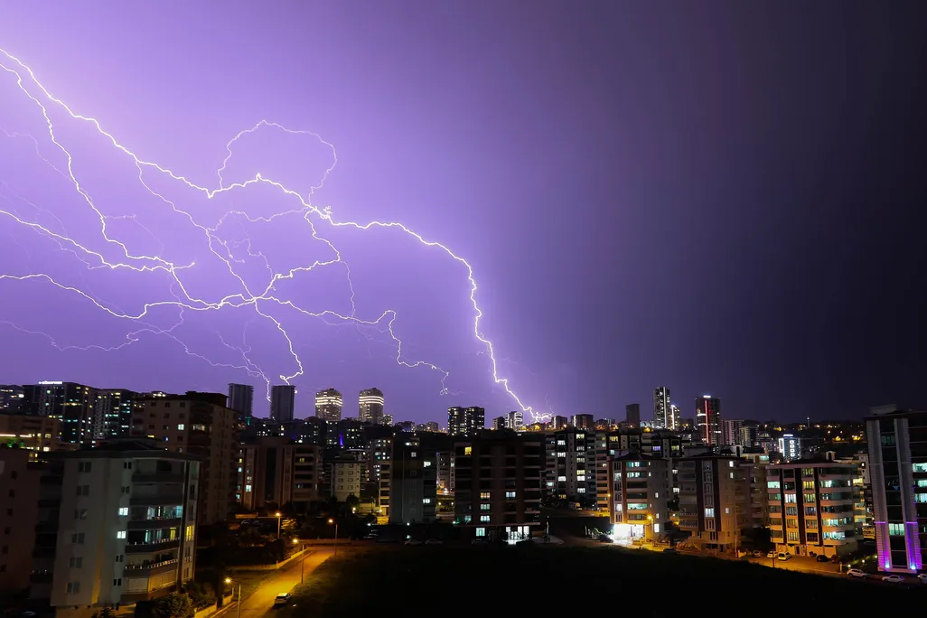 Lightning in the night sky above buildings