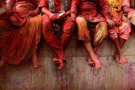 Revelers sit on a wall in Mathura. 