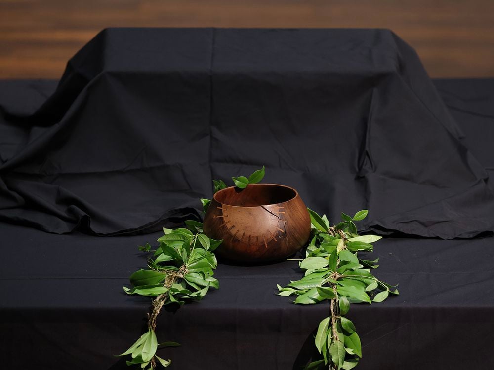Covered in black cloth, a box containing human remains sits on a table during a repatriation ceremony in Berlin on February 11, 2022