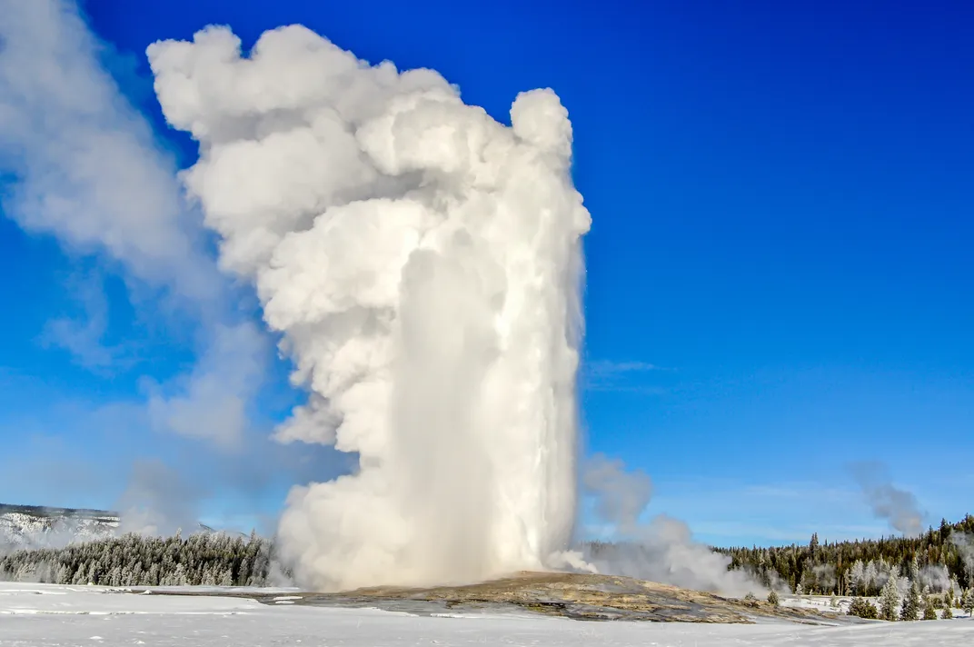 Old Faithful erupting in winter