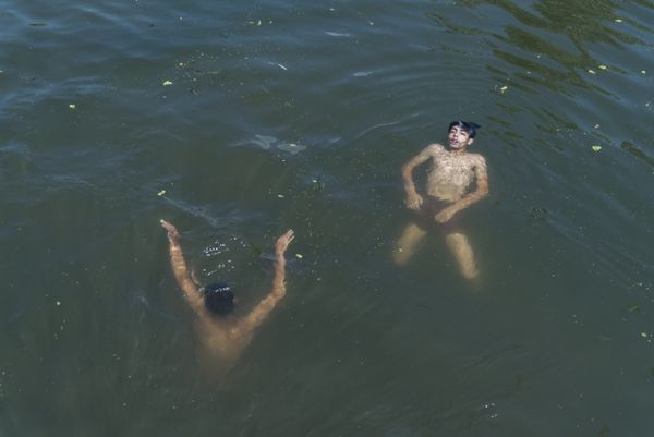 Kids joyfully float in the refreshing water, finding respite from the scorching summer heat. thumbnail