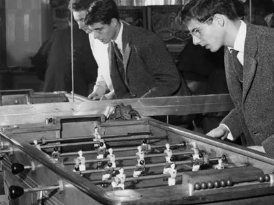 A group of young Parisians playing foosball at a cafe in 1958.