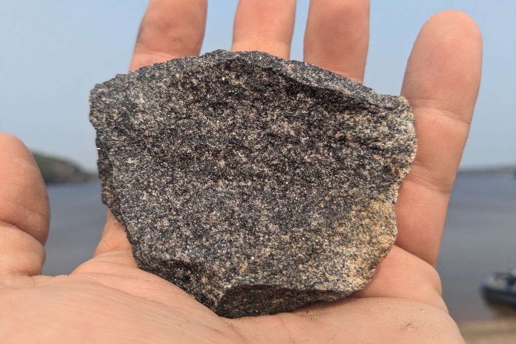 Geologist Michael Ackerson holds a sample