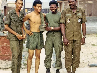 Clyde Romero, James Casher, Eldridge Johnson, and Bob Farris in military green