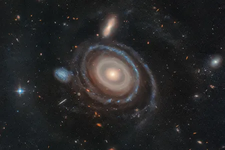 LEDA 1313424, nicknamed the Bullseye, appears next to the small blue dwarf galaxy on its immediate left.