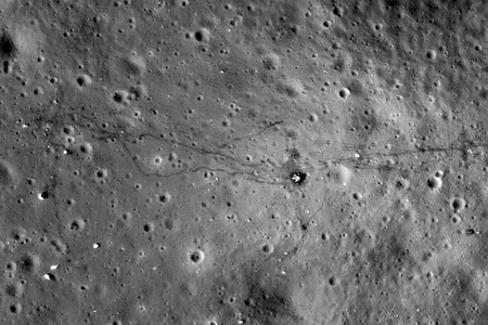 The Apollo 17 landing site, as photographed by the Lunar Reconnaissance Orbiter in 2009 and 2011. To the left of Challenger&rsquo;s descent stage (just right of center) are the astronauts' footpaths. To the right are tracks left by their moon buggy.
