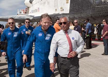 CAPE CANAVERAL, Fla. -- NASA Administrator Charlie Bolden leads the STS-133 crew to media representatives waiting on the Shuttle Landing Facility at Kennedy Space Center in Florida to hear statements about space shuttle Discovery's final spaceflight mission. The STS-133 crew returned to Earth at 11:57 a.m. on Runway 15, completing a 13-day, 5.3-million-mile mission to the International Space Station. STS-133 delivered the Permanent Multipurpose Module, packed with supplies and critical spare parts, as well as Robonaut 2, the dexterous humanoid astronaut helper, to the orbiting outpost. STS-133 was Discovery's 39th and final mission. This was the 133rd Space Shuttle Program mission and the 35th shuttle voyage to the space station. Photo credit: NASA/Kim Shiflett