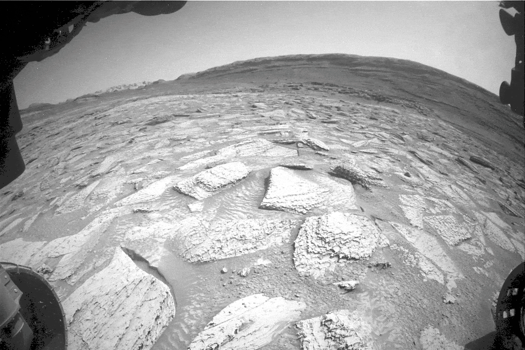 gif of Curiosity's robotic arm getting the rock unstuck