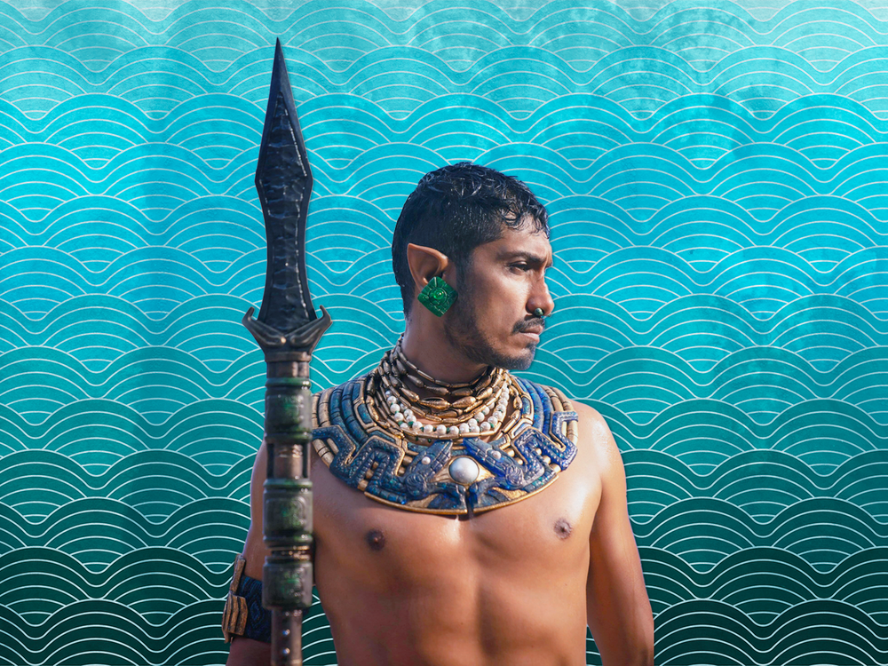 Illustration of Namor, king of Talokan, in front of a blue ocean-themed background