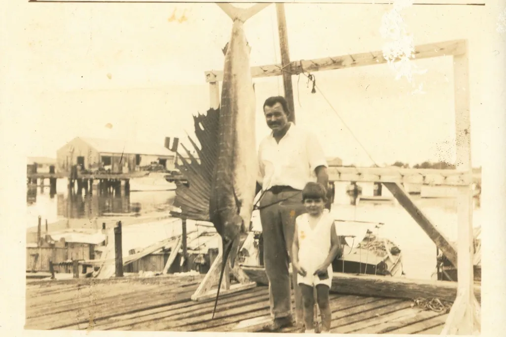 Ernest Hemingway and his middle son, Patrick, pose with a record 119.5-pound Atlantic sailfish caught off Key West, Florida, in May 1934.
