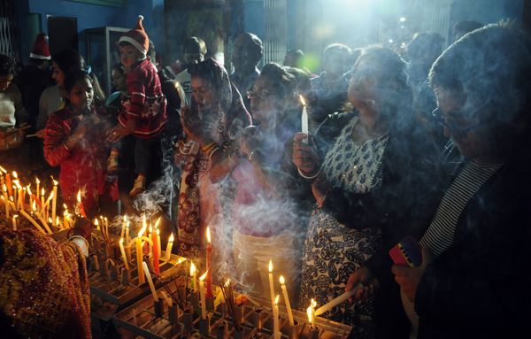 The Indian Christian devotees offering a prayer with lit candles. thumbnail