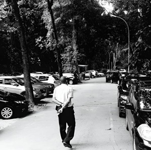 Lone worker in the jungle of parked cars thumbnail