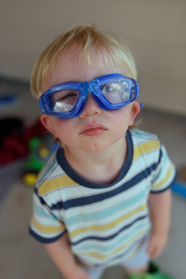 A toddler looking the clouds through goggles thumbnail