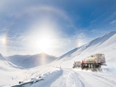 With a sunny &ldquo;halo&rdquo; to point the way, a truck climbs into the Brooks Range towards Atigun Pass, heading for Fairbanks after departing the oilfields of Prudhoe Bay.

