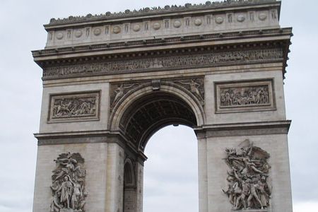 Traffic whips around Paris' grandest arch while tourists savor the view from the top.