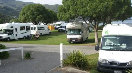 Caravans cram this campground in Akaroa in a scene typical of New Zealand. Cyclists and hikers, when camped among such fleets of vehicles, may wish for a patch of privacy somewhere in the nearest forest—if only there were access.