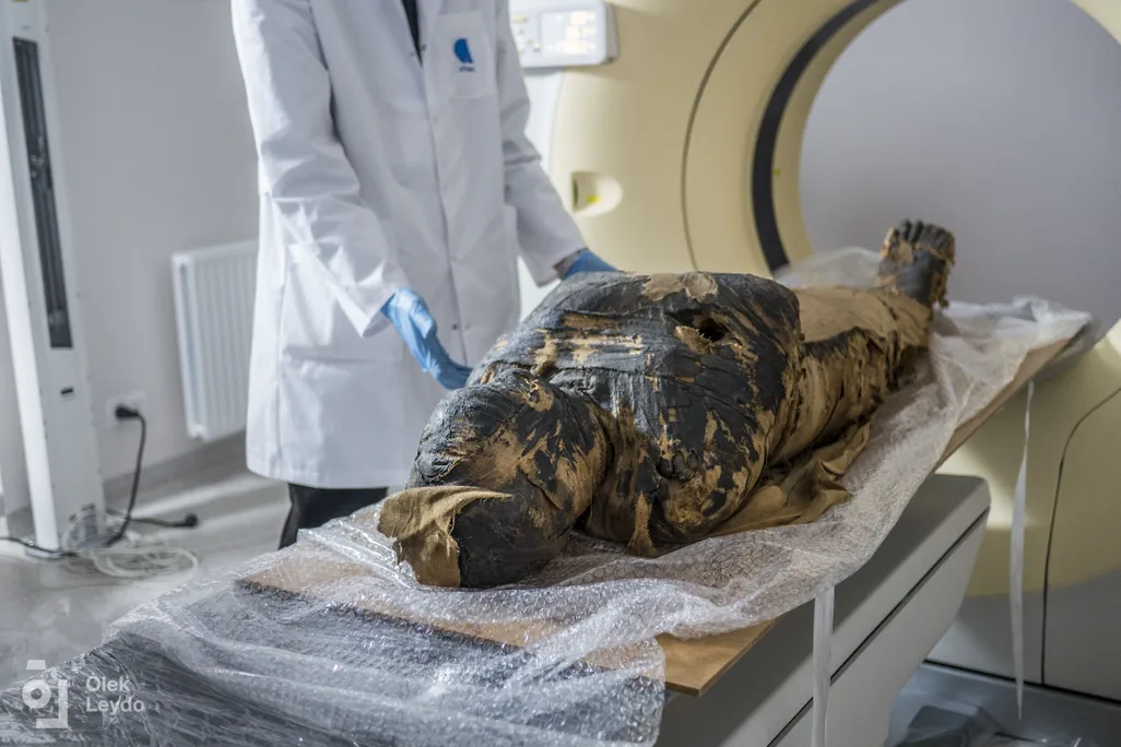 Mummy on gurney going inside of a hospital scanner