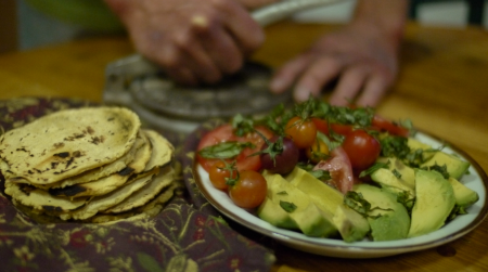 Hot, handmade corn tortillas may be among the simplest and tastiest staple food items of the world. Here, the author presses out a batch.