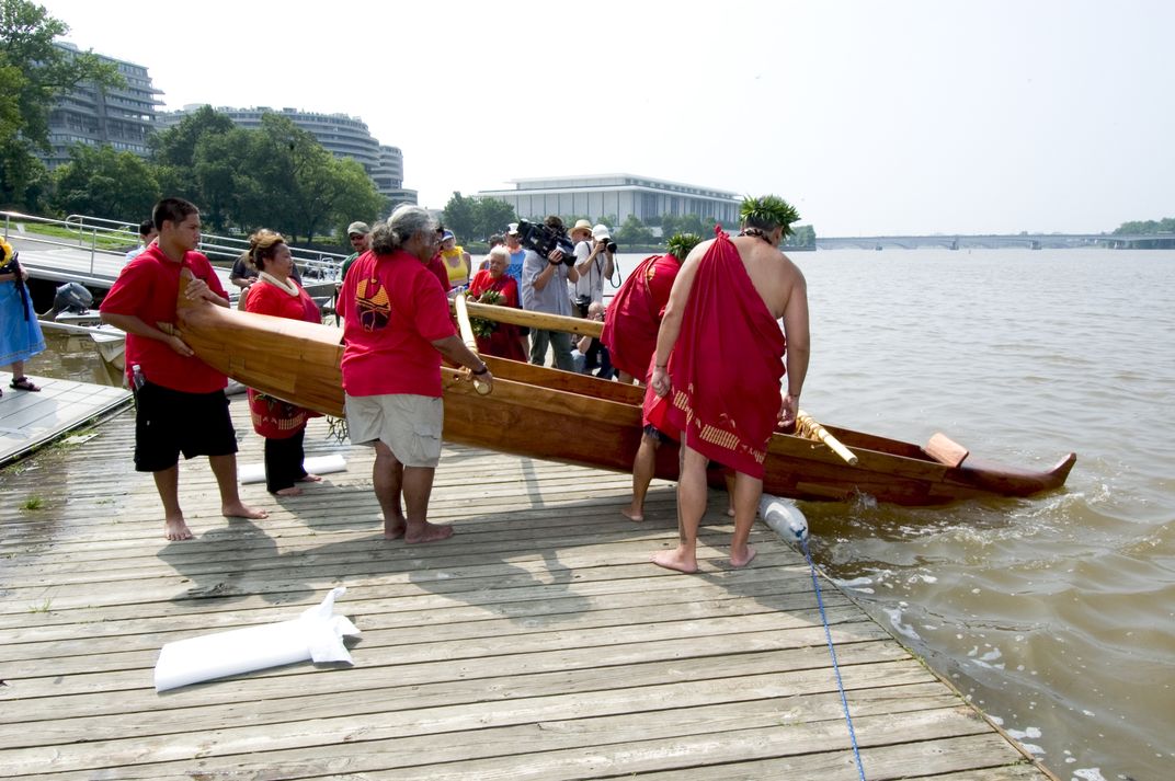 A Hawaiian canoe is guided into the Potomac River in Washington, D.C.