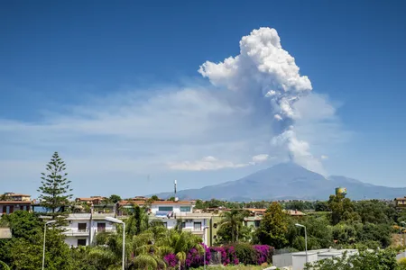 A plume of ash and gas rises from Mount Etna on the Italian island of Sicily on Monday. The eruption also featured lava fountains and a pyroclastic flow.