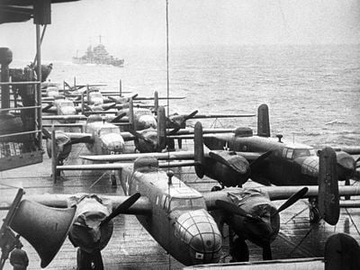 The flight deck of the U.S. aircraft carrier Hornet, some 800 miles off Tokyo Japan, where it shows some of 16 Billy Mitchell (B-25) Bombers, under the command of Major Jimmy Doolittle, just before they were guided off flight deck for historic raid on Tokyo, April of 1942.