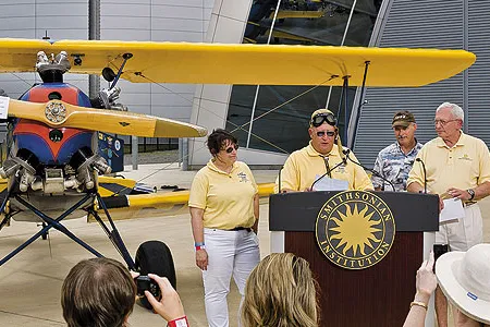 An emotional Gene Breiner (at lectern, with daughter Joyce and General Jack Dailey, director of the National Air and Space Museum) donated Plane Jane to the Museum this past June in hopes of inspiring future pilots.