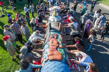 Members of the public take part in a blessing of the Lummi Nation totem pole in San Leandro, California, on June 3. The House of Tears Carvers toured the pole around the West Coast before embarking on a two-week journey to Washington, D.C. 
