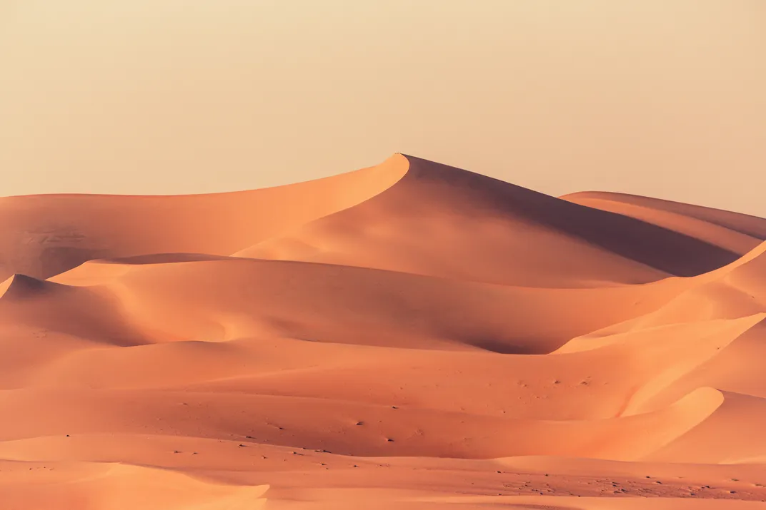 A shadowy orange sand dune in the United Arab Emirates' Arabian Desert
