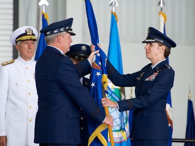 General Robinson, right, is handed the Pacific Air Forces flag during a ceremony yesterday.