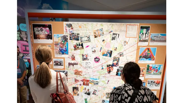 Educators gather around a map
