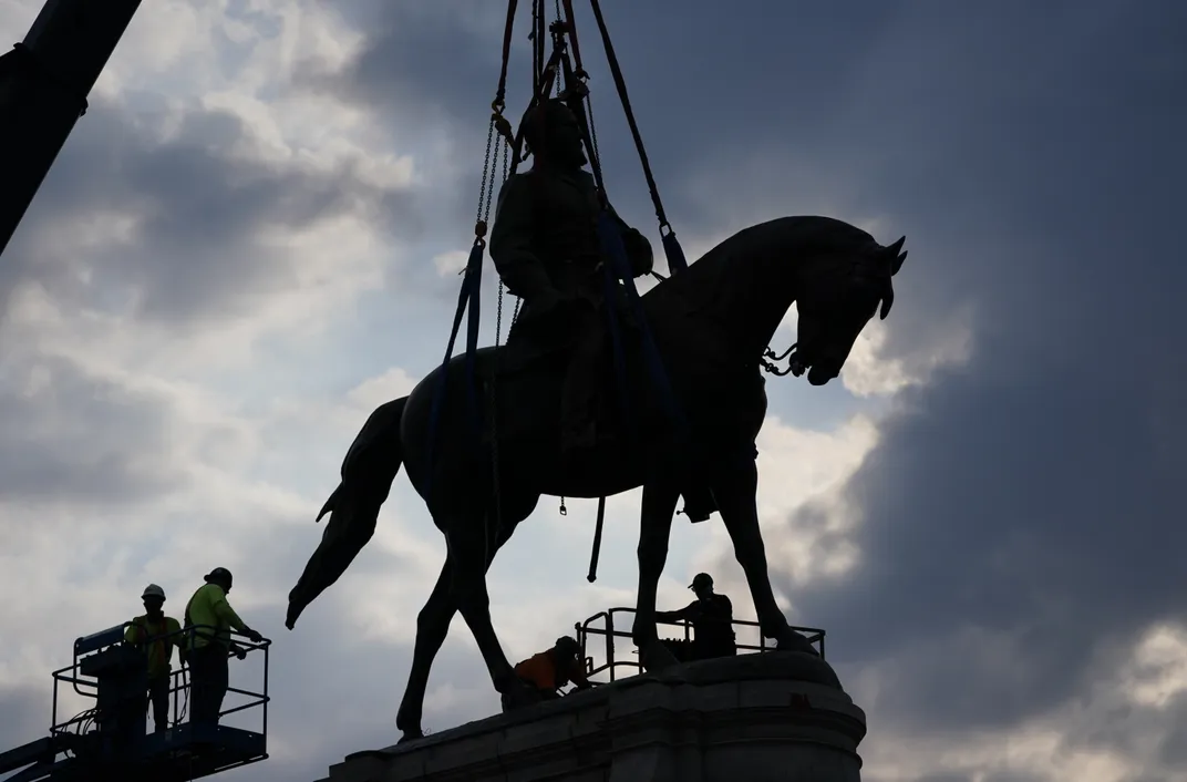 Crews prepare to remove a statue of Confederate General Robert E. Lee from Richmond's Monument Avenue on September 8, 2021
