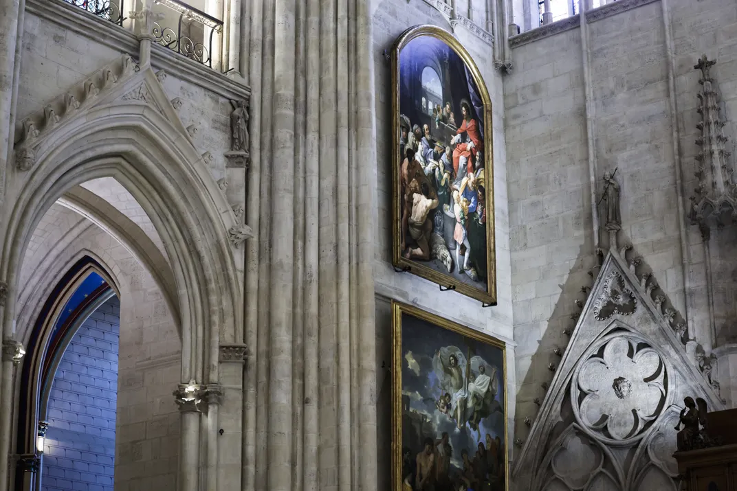 Artwork hanging on the wall inside Notre-Dame Cathedral