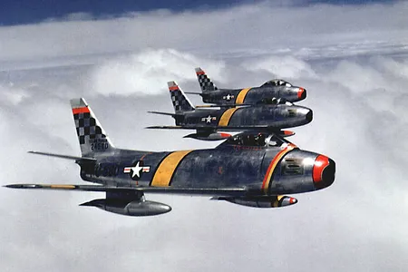 Three F-86s flying in formation over Korea.